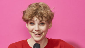 Tyra har koll på allt som händer kring MGP. Glad flicka med mikrofon i handen