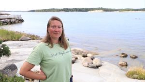Sonja Salovius-Laurén arbetar som specialforskare i marinbiologi. En kvinna står en sommardag vid en klippa.