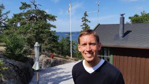 Gustav utanför sommarhuset. Gustav Ahlman har konverterat från Svenska Kyrkan till den Katolska kyrkan. Korpo augusti 2019.