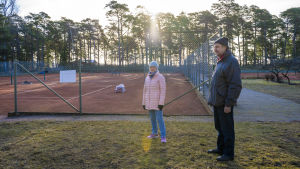Hangö högstadiums och Hangö gymnasiums rektor Tanja Koivisto och Hangö tennisklubbs ordförande Leif Wikström har siktet inställt på att Hangö ska få landets första gymnasium med padel som specialitet. En kvinna och en man står bredvid tennisbanor. Det är ute, tidig vår och gäller utomhusbanor.