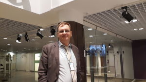 Professor Kai Nordlund ser mycket positivt med reformen. Kai Nordlund står vid en glasvägg