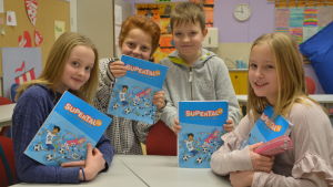 Sissi Karlsson, Linus Blomander, Wolter Hildén och Emma Johansson. Sissi, Linus, Wolter och Emma sitter i klassrummet vid en pupet. De håller i sina matematikböcker, tittar in i kameran.