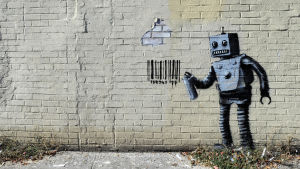 seinämaalaus, jossa robotti on spreijannut seinään viivakoodin