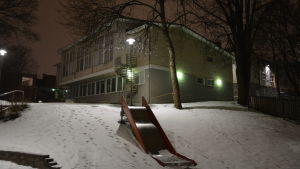 Kärnhuset ska rivas. Kärnhuset vid Sirkkala skola, en gul tvåvåningsbyggnad en snöig vinterkväll.