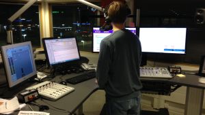 Ett korrekt språk är en del av det journalistiska uppdraget. Bild av reporter bakifrån i Yle Åbolands radiostudio.
