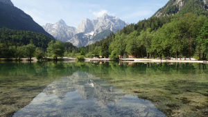 Sagolikt bergslandskap i det natursköna Slovenien. Bergslandskap speglas i vattendrag i Slovenien.