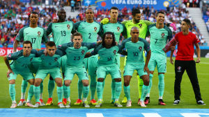 Bollkallen hade is i magen framför kameralinsen. En bollpojke poserar med Portugals herrlandslag i fotboll.