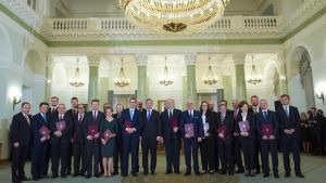 Coronaepidemin har ökat regeringens och presidentens popularitet den polska regeringen och president Andrzej Duda står uppställda i en festsal