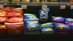 Det är inte alltid samma sorts ost som får larmsystem, men det brukar vara större ostpaket eftersom just de snattas oftast. En hylla med ost. På ostpaketen finns gula lappar.