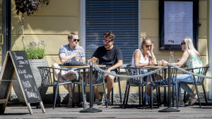 Restaurangägarna har snabbt åtgärdat brister i regleringen. Flera personer sitter på en uteservering en solig sommardag.
