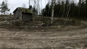 Det här området ska jämnas ut och bli utsiktsplats vid toppen av motionstrappan. Ladan är tyvärr i så dåligt skick att den måste rivas. En gammal lada och en gropig väg.