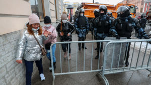 ...Också fotgängartrafiken har begränsats. Personer promenerar runt vägstängsel på en trottoar i Moskva.