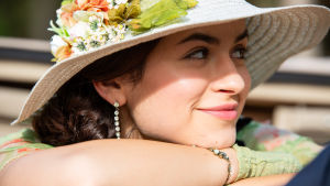 Carlota (Mikaela Lupu) hymyilee kukkahatussa sarjassa Vidago Palace