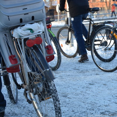 Flera cyklister väntar vid vägen i centrala Åbo.