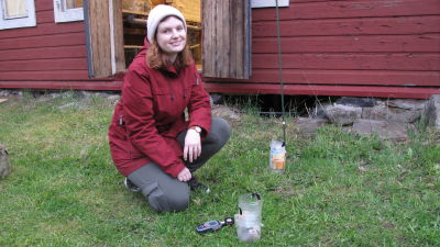 Kvinna sitter på huk utanför arbetsrum.