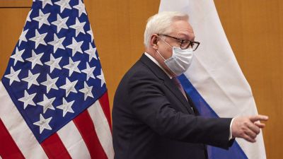 Rysslands vice utrikesminister Sergej Rjabkov. I bakgrunden till vänster USA:s flagga och till höger Rysslands.