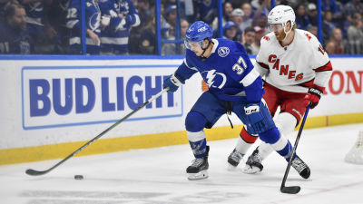 Dougie Hamilton skuggar Yanni Gourde på isen.