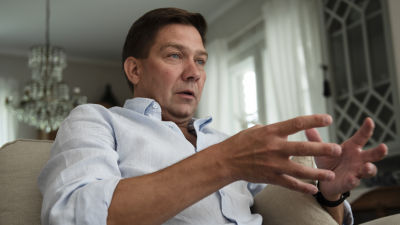 Thomas Blomqvist sitter och gestikulerar.