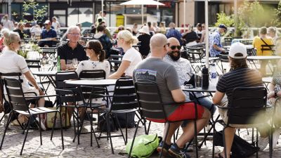 Människor sitter på en uteservering i Helsingfors.