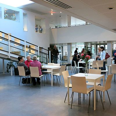 Ihmisiä istuu taidemuseon aulakahviossa.