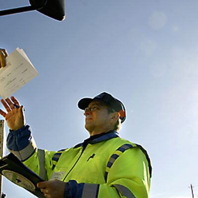 Rekan kuljettaja ojentaa poliisille auton asiakirjoja ohjaamosta.