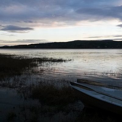 Vene joenrannassa aamuhämärässä.