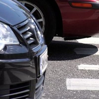 cars stopped at a pedestrian zebra crossing