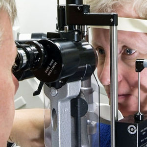 Hannu Uusitalo tutkii potilaan silmiä.