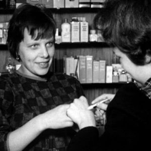 Nainen kokeilee kosmetiikkaa kaupassa