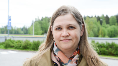 Tuija Nygård utomhus med en färggrann skarf runt halsen.