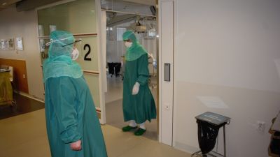 Hoitajia kulkee koronapotilaiden luo ovesta Tyksin teho-osastolla.