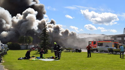 brandmän framför brinnande affärshus