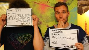 Kuvassa YleX Jälki-istunnon Viki ja Mäkkäri omien #jälkkä -lappujen kanssa. Vikin lapussa lukee "Valehtelin että en tiedä mikä on #jälkkä" ja Mäkkärillä puolestaan "Huijasin teitä kaikkia!" // Kuva: Timo "Timppa" Launonen
