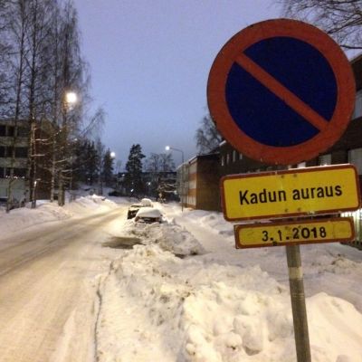 Väliaikainen pysäköintikieltomerkki lumisen kadun varressa