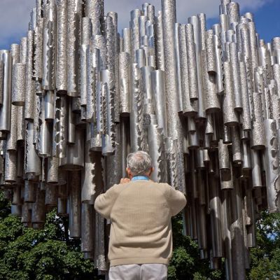 Tourist photographing Sibelius monument.