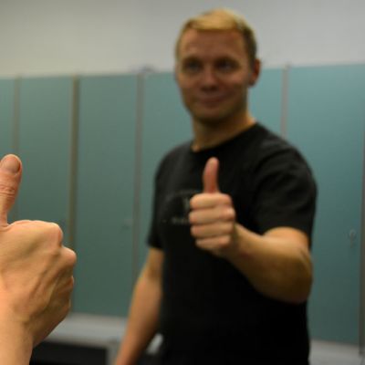 Mies nostaa peukaloaan kannustavasti peilin edessä.