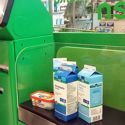 Mies suorittaa ostoksia itsepalvelvelukassalla kaupassa