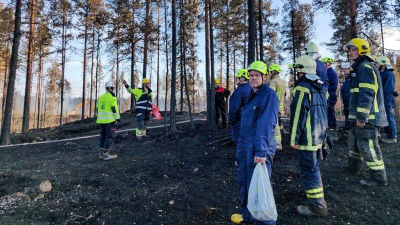 Frivilliga brandkårister i skog.
