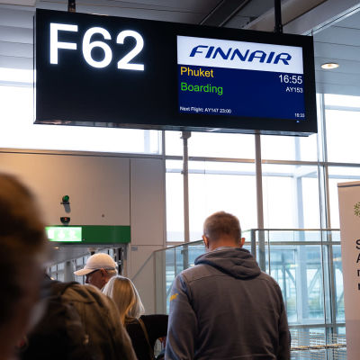 Passagerare på väg att borda Finnairs plan från Stockholm till Phuket.  