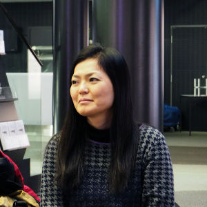 Minamin äiti Emi Yoshida seuraa haastattelua taustalla. Emi on ammatiltaan kalligrafi.