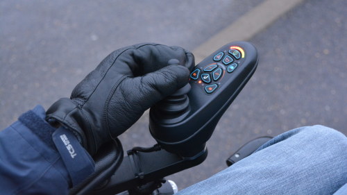 Närbild på Jonas hand som kör rullstolen