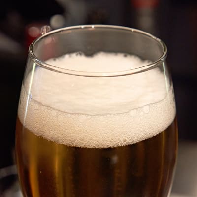 A foaming glass of beer.