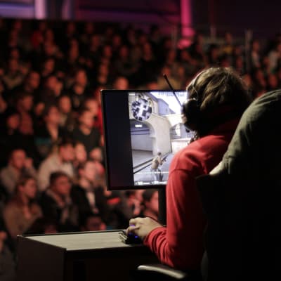 spelare på Assembly där en massa människor sitter i publiken i bakgrunden.
