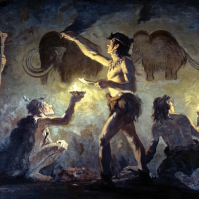 Förhistoriska människor i en grotta, målande på väggen.