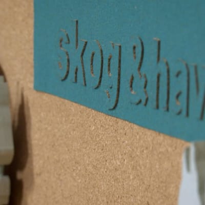 Texten skog och hav utskurna bokstäver
