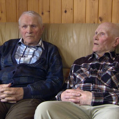 Eino ja Väino Kinnunen istuvat kotisohvallaan Suomussalmella.