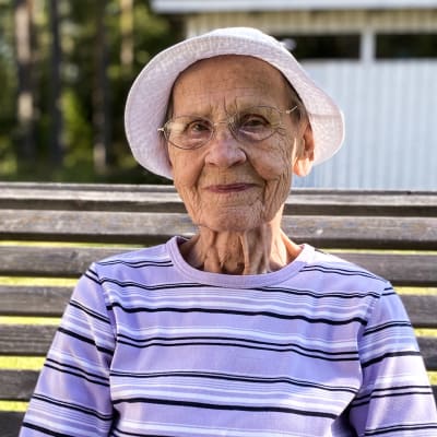 Elsa Pekkala 91 vuotta istuu kotipihassaan keinussa. 