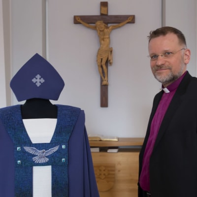 Kuopion piispa Jari Jolkkonen ja Helena Vaarin hänelle suunnittelema piispankaapu.