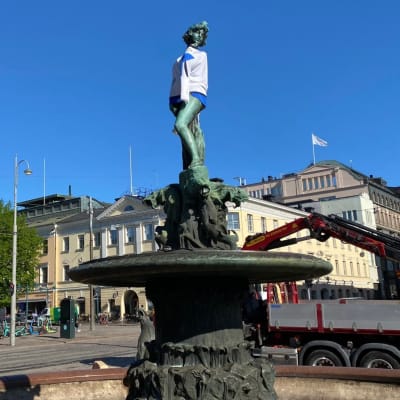 Havis Amanda insvept i Finlands flagga.