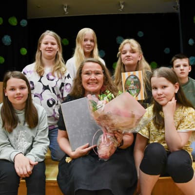 Luku-Varkaus palkinnon saaja Maami Snellman voittajan valinneen lapsiraadin ympäröimänä.